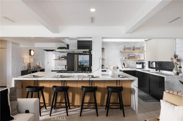 35651 Beach Rd, Dana Point, CA 92624 - kitchen with a sink, open shelves, beamed ceiling, a breakfast bar, and a large island