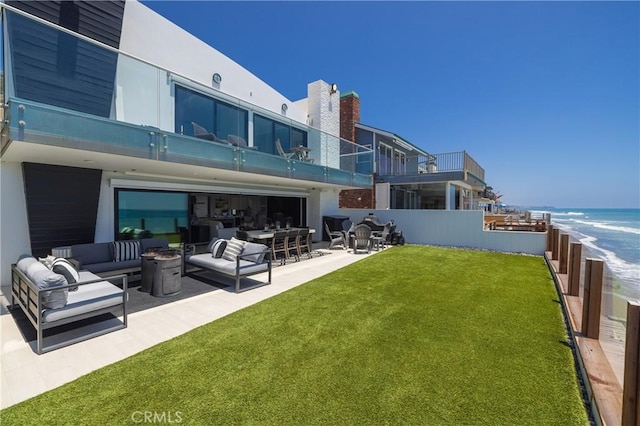 35651 Beach Rd, Dana Point, CA 92624 - rear view of house with an outdoor hangout area, a patio, a water view, and an attached garage