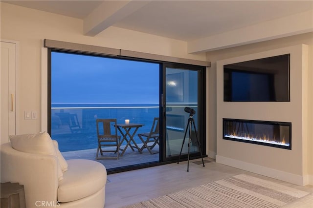 35651 Beach Rd, Dana Point, CA 92624 - living area with beamed ceiling, wood finished floors, baseboards, and a glass covered fireplace