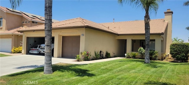 view of front of house with driveway, a front yard, a tiled roof, and stucco siding