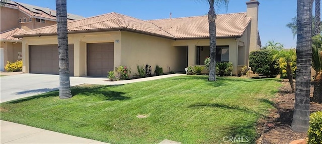 view of front of house featuring an attached garage, a tile roof, driveway, stucco siding, and a front lawn