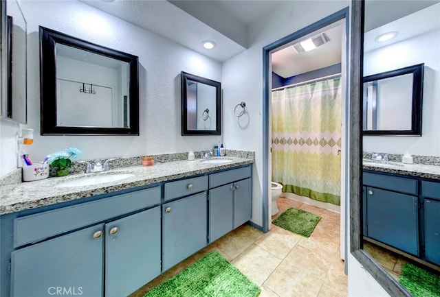 bathroom featuring a shower with curtain, vanity, tile patterned flooring, and toilet