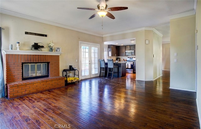 living room with french doors, dark wood-type flooring, and crown molding