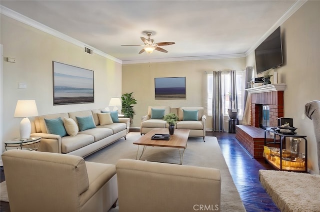 living room featuring ceiling fan, a fireplace, dark hardwood / wood-style floors, and ornamental molding