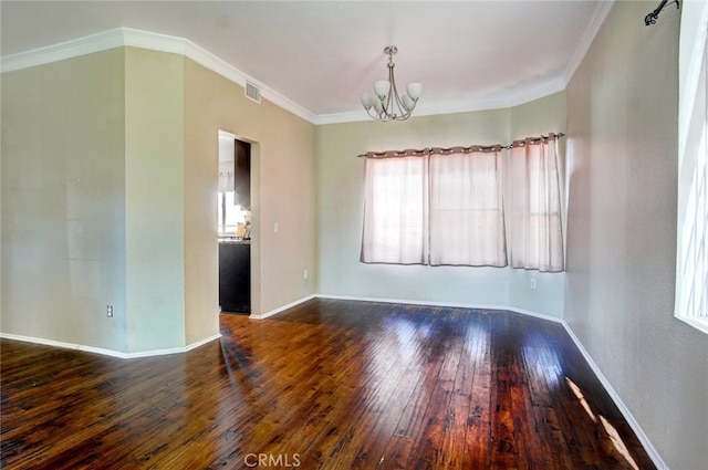 unfurnished room with an inviting chandelier, ornamental molding, and dark hardwood / wood-style flooring