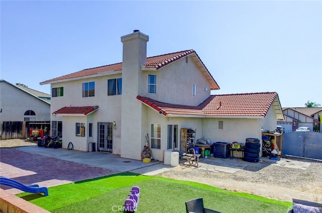 back of property featuring central air condition unit and a patio area