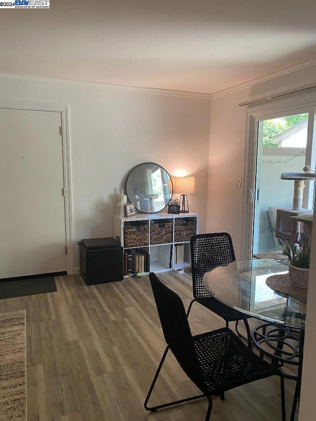 dining room featuring wood-type flooring and ornamental molding