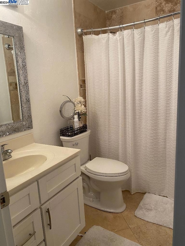 bathroom with tile patterned flooring, vanity, toilet, and a shower with shower curtain