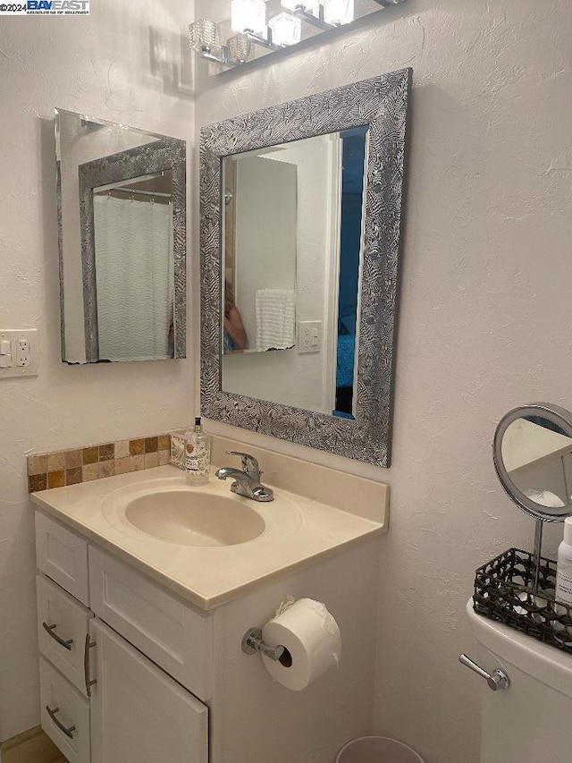 bathroom featuring vanity and toilet