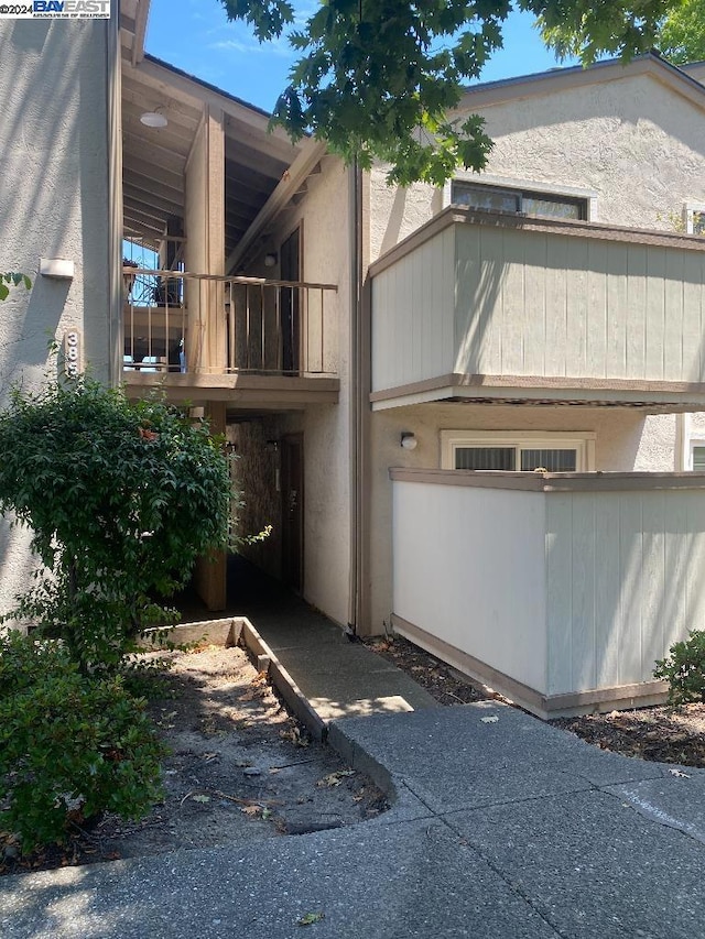 view of side of property featuring a balcony