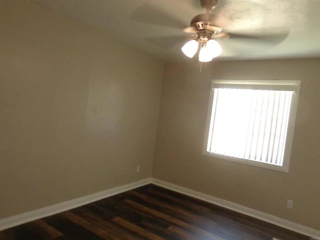 empty room with ceiling fan and dark hardwood / wood-style floors