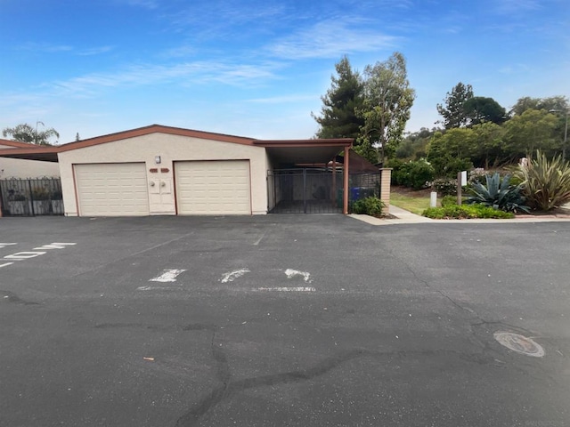 view of front of home with a garage and a carport