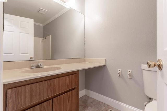 bathroom featuring vanity, ornamental molding, and toilet