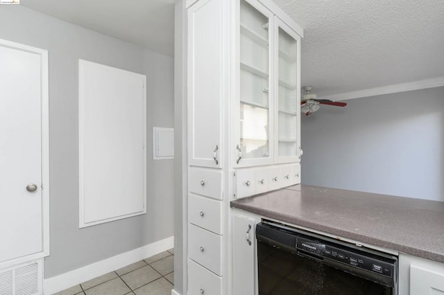 kitchen with white cabinets, light tile patterned flooring, crown molding, and black dishwasher