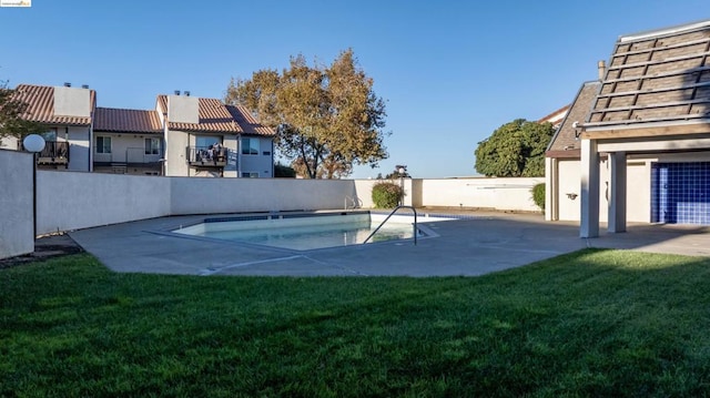 view of swimming pool with a patio area and a lawn