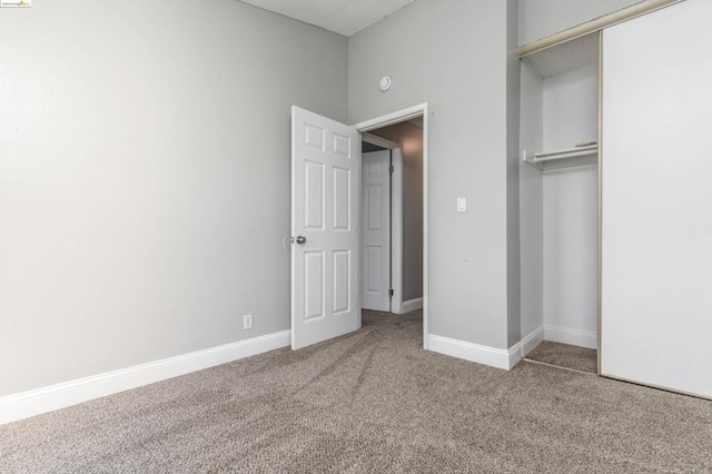 unfurnished bedroom with carpet and a closet