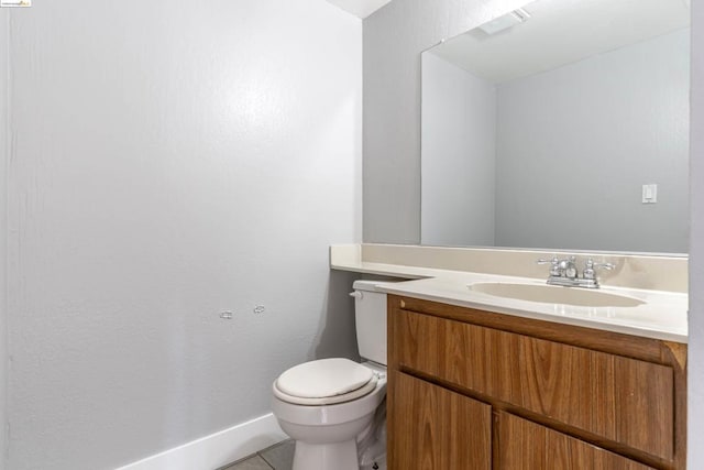 bathroom with tile patterned flooring, vanity, and toilet