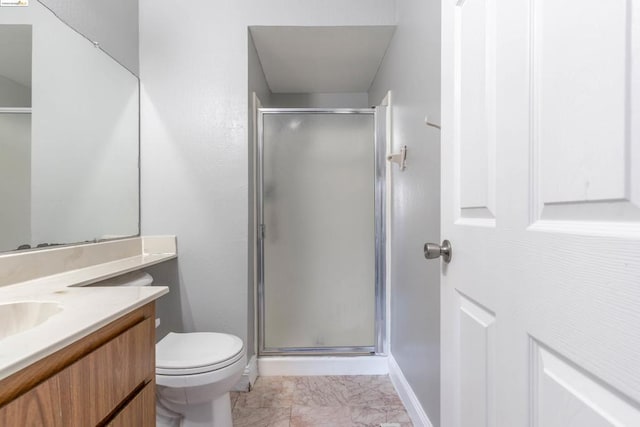 bathroom with vanity, a shower with shower door, and toilet