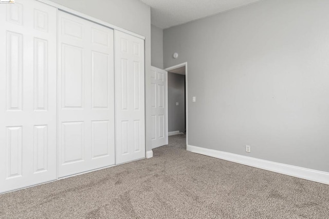 unfurnished bedroom with carpet flooring and a closet