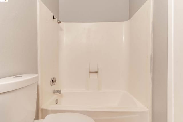 bathroom featuring toilet and tub / shower combination