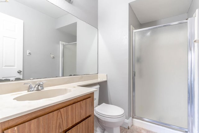 bathroom with toilet, a shower with door, vanity, and tile patterned flooring