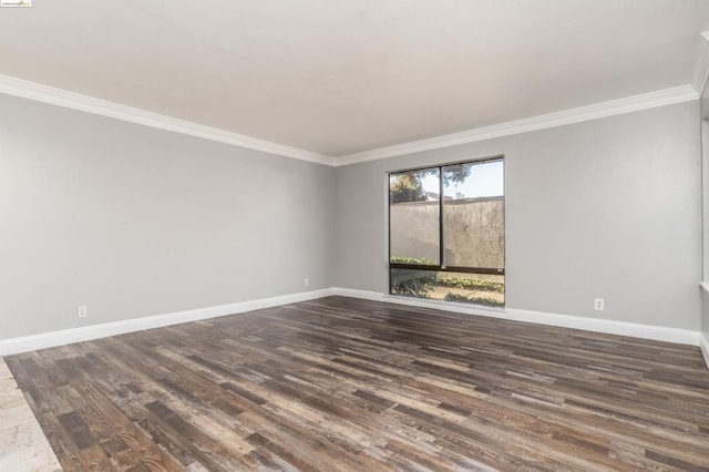 spare room with crown molding and dark hardwood / wood-style floors