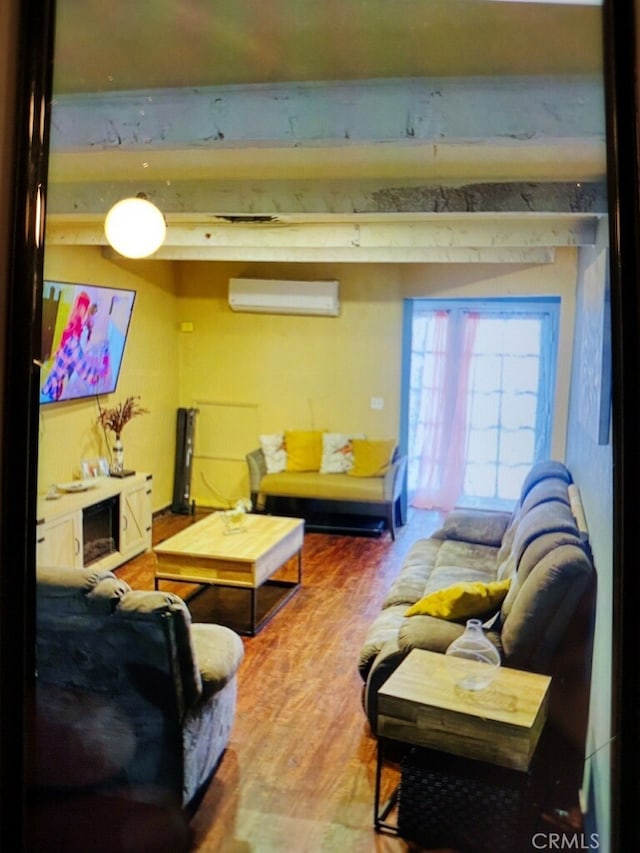 living room with wood-type flooring, beam ceiling, and a wall mounted AC