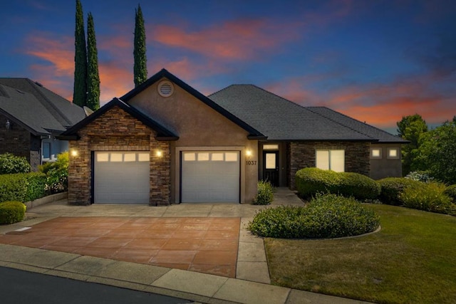 view of front facade with a lawn and a garage