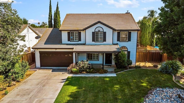 view of front of home featuring a garage, a porch, and a front yard