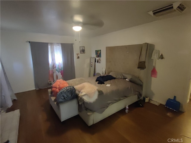 bedroom with ceiling fan and dark hardwood / wood-style flooring