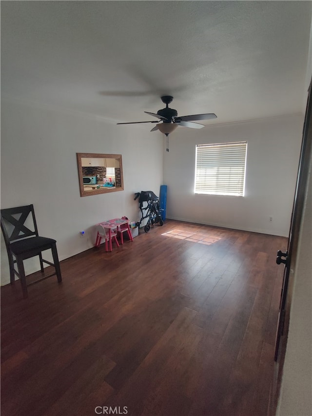 interior space featuring ceiling fan and dark hardwood / wood-style flooring