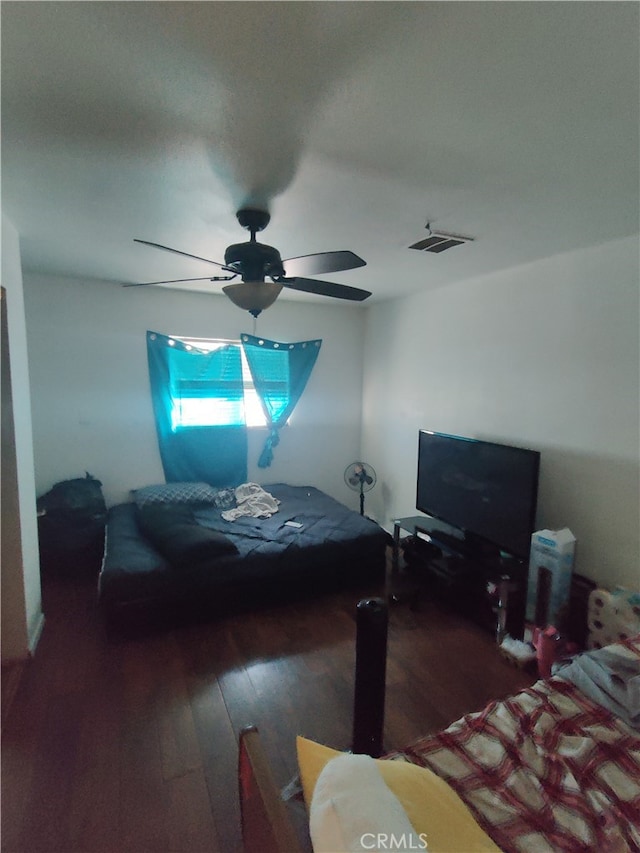 bedroom with ceiling fan and dark wood-type flooring