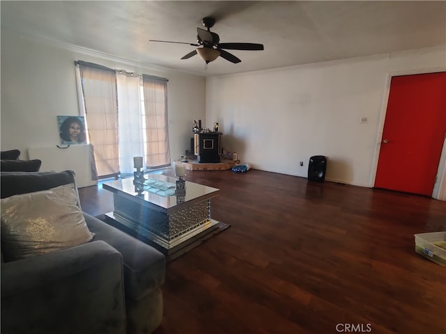 living room featuring ceiling fan, dark hardwood / wood-style floors, and ornamental molding