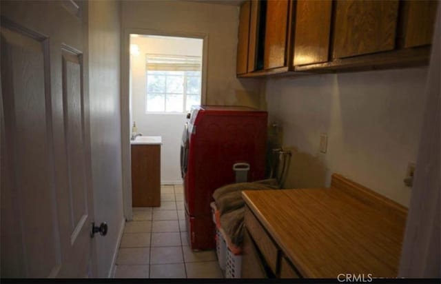 8043 Mojave Tropico Rd, Mojave, CA 93501 - laundry area featuring light tile patterned floors, cabinet space, and independent washer and dryer