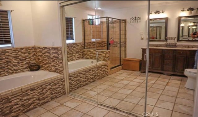 8043 Mojave Tropico Rd, Mojave, CA 93501 - bathroom featuring tile patterned floors, a garden tub, double vanity, crown molding, and a tile shower