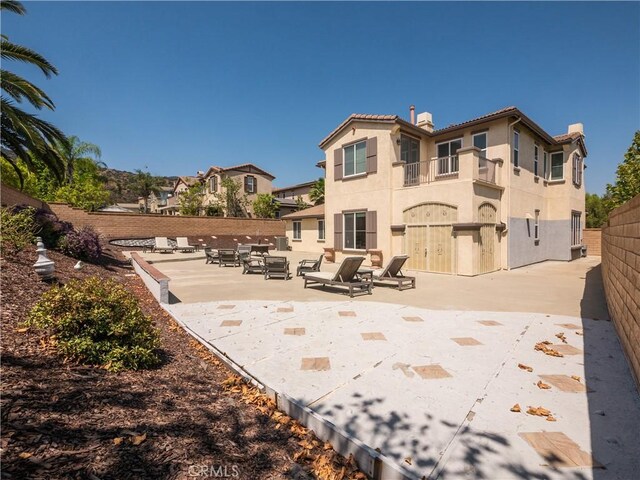 back of property with a patio