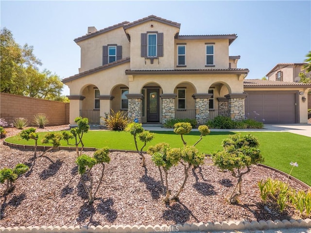 mediterranean / spanish house featuring a garage and a front lawn