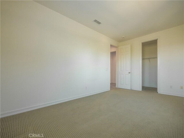 unfurnished bedroom featuring carpet floors and a closet