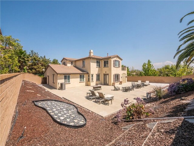 rear view of property featuring a patio area