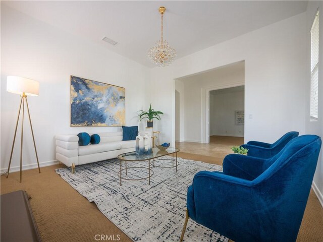 living room featuring carpet floors and a chandelier