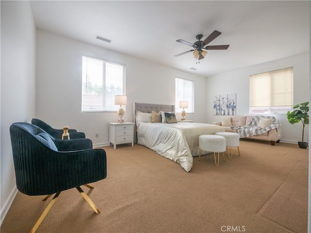 bedroom featuring multiple windows, ceiling fan, and carpet flooring