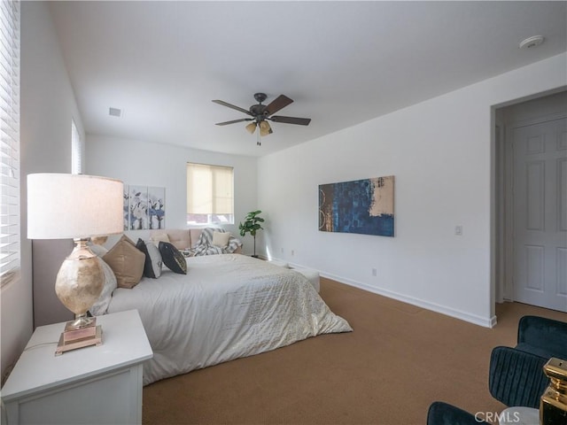 bedroom featuring ceiling fan and carpet