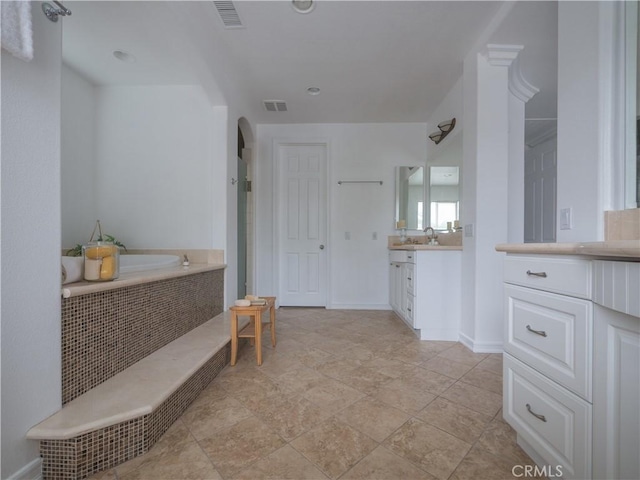 bathroom featuring vanity and a tub