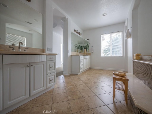 bathroom featuring tile patterned flooring and vanity