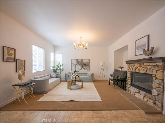 living room featuring a notable chandelier and a fireplace