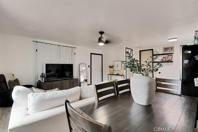 dining area with ceiling fan and wood-type flooring