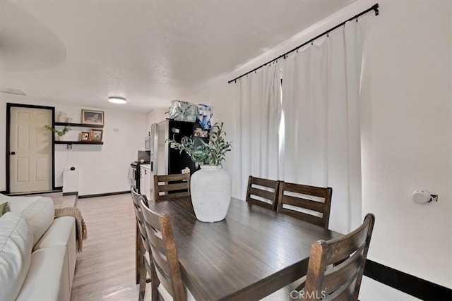 dining space featuring light wood-type flooring