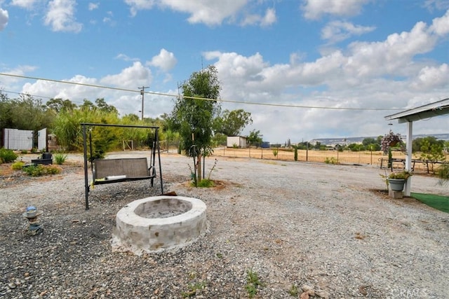 view of yard with an outdoor fire pit