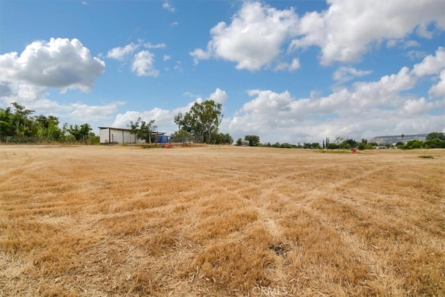 view of yard with a rural view