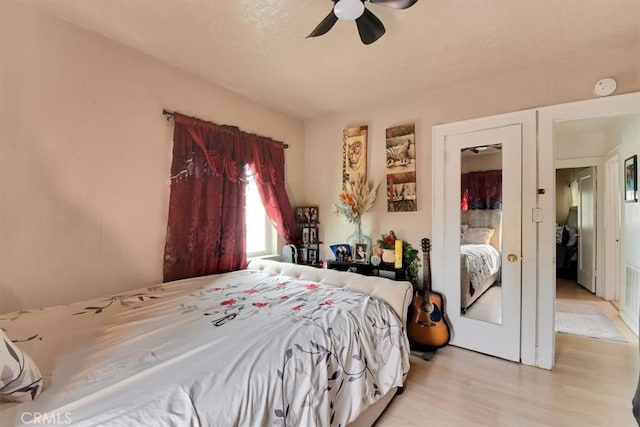 bedroom with light hardwood / wood-style flooring and ceiling fan